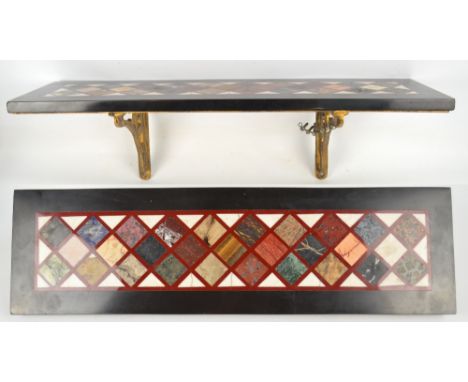 A 19th century black slate and specimen polished hardstone set shelf, the main rectangular panel set with lozenge shaped inla