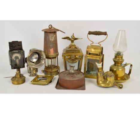A group of lamps including a Regalite bicycle lamp, an L.N.W.R. lamp with Vaporite cap, a small brass hanging lamp, unnamed m