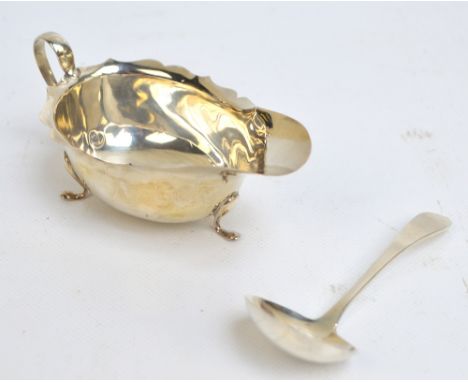 An Elizabeth II hallmarked silver cream jug, Birmingham 1967, length 13cm, and an Elizabeth II hallmarked silver small ladle,