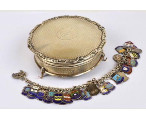 A George V hallmarked silver circular trinket box, the engine turned decorated hinged lid centred with a circular panel inscr