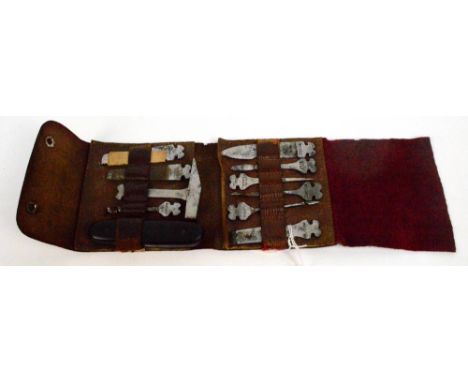 A late 19th/early 20th century Sabina eleven piece tool kit including a knife, file, corkscrew, etc, in leather pouch.
