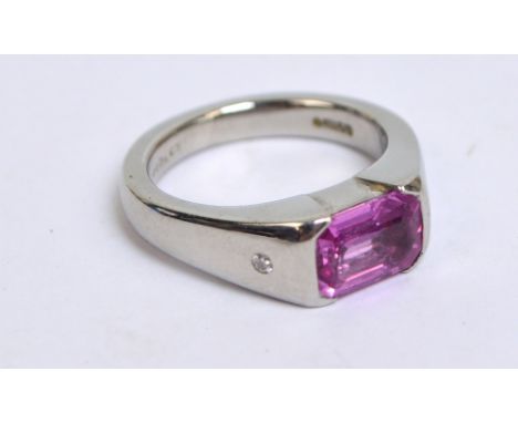 BOODLE & DUNTHORNE; a platinum, pink topaz and diamond ring, the emerald cut topaz with tiny diamonds set to the shoulders, f