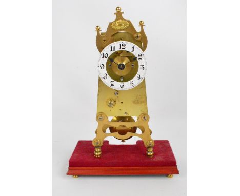 An early 20th century brass single fusee mantel clock, the white enamel dial set with Arabic numerals and with angled main bo