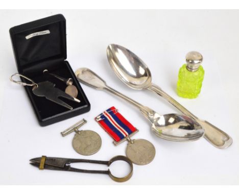 A modern hallmarked silver golf divot fixing tool keyring, a hallmarked silver golf tee, both Birmingham 1991, a sterling sil