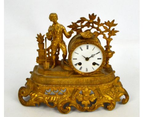 A c.1900 gilt spelter figural mantel clock with drum type eight day movement, with white enamel dial set with Roman numerals 