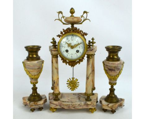 A late 19th century French veined marble gilt metal mounted three clock garniture, the urn finial above circular white enamel