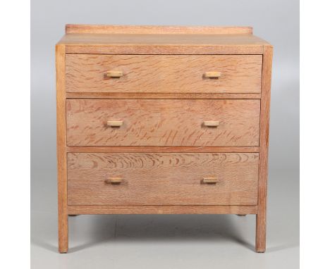 With three long graduated drawers, displaying the Heals &amp; Son Ltd makers label to the interior of the top drawer. Height 