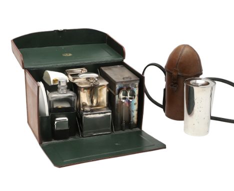 A leather cased picnic set, including a kettle and burner, storage tins, cups and saucers and other items, with a retail name