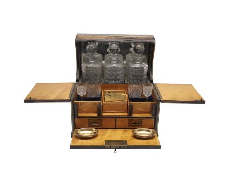 the satinwood veneered interior containing three cut glass decanters and four drinking glasses, a cigar cutter and vesta hold