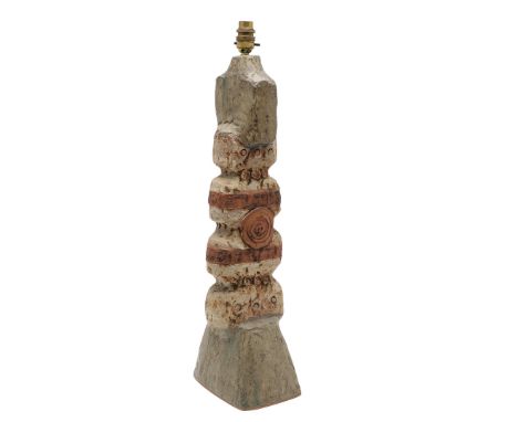 A large 'totem' shaped stoneware pottery lamp, with incised and applied motifs, and a plain glaze to the top and base. 58cms 