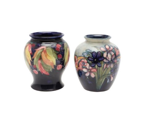 Including a William Moorcroft vase in the Spring Flowers design, with impressed marks and painted signature (16cms high), and