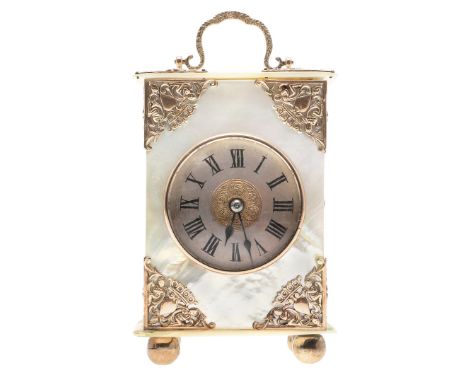 the dial with ornate pierced central panel and Roman numerals. the mother of pearl case with gold plated mounts, depicting ch