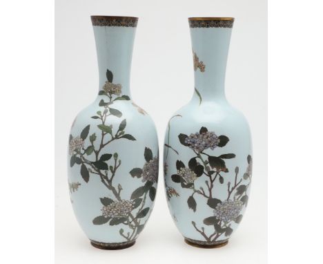 Meiji period, a large pair of Japanese cloisonne vases with tapering necks, decorated with birds amongst flowering trees and 