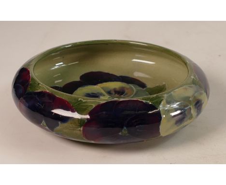 William Moorcroft footed dish decorated with Pansies on light green and ground, d.11cm.