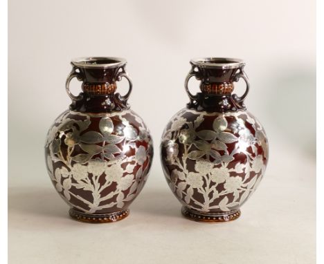 A pair of George Jones twin handled vases decorated with silver overlay floral design and trims. Height 15cm 