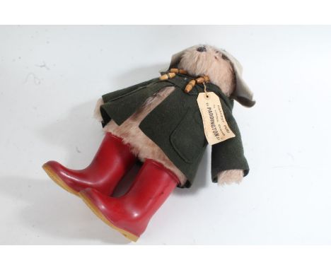 Gabrielle 'Paddington Bear', with felt hat, green duffle coat and red Dunlop boots, with paper label, approx. 46cm tall