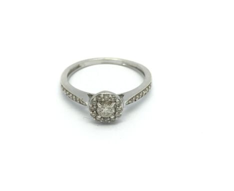 A 9carat white gold ring set with diamonds and with further diamonds set into the shank. ring Size J-K