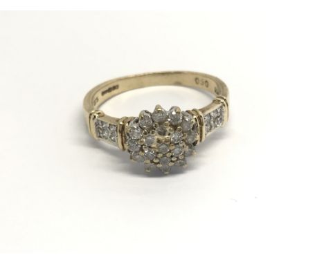 A 9carat gold ring set with a pattern of diamonds ring size L