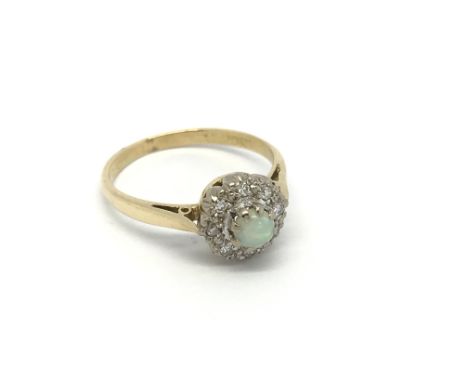 A 1950s Vintage gold ring set with an opal and diamonds ring size L.