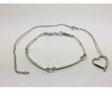 A silver and diamond bracelet and a silver heart shaped necklace (2).