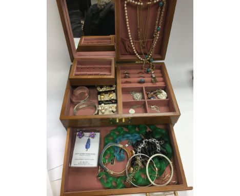 A birds eye maple jewellery box containing various costume jewellery items, mainly silver.