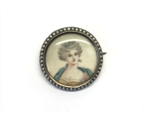 An antique silver and pearl miniature portrait brooch of a maiden