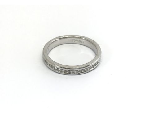 An 18carat white gold half hoop eternity ring set with a row of diamonds ring size M.