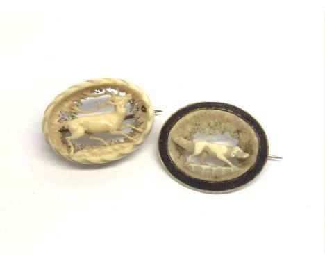 A pair of Victorian carved ivory hunting brooches showing a dog and a stag