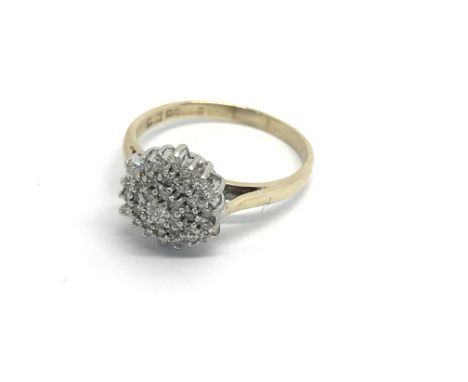 A 9carat gold ring set with a pattern of diamonds ring size K