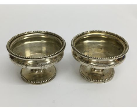 A pair of matching hallmarked silver pedestal table salts with marks for Sheffield 1844, Martin, Hall &amp; Co (Richard Marti