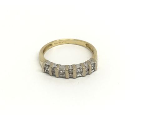 An 18carat gold ring set with a row of alternating brilliant cut and baguette diamonds ring size K