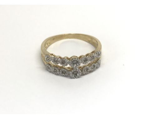 A 9carat gold ring set with two open rows of diamonds ring size M