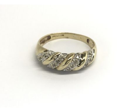 A 9carat gold ring set with a pattern of diamonds ring size O-P