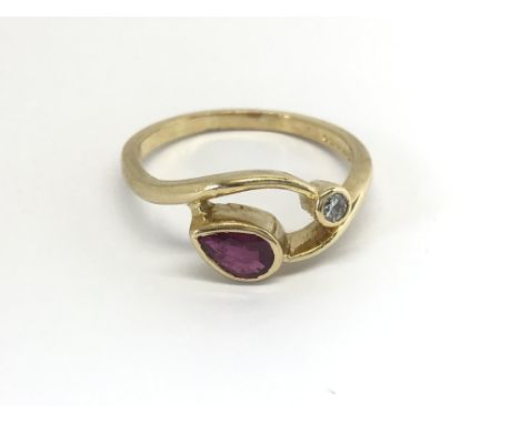 An 18carat gold ring set with a good size pear shaped ruby and diamond. ring size U-V