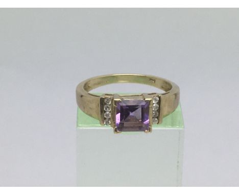 An 18ct gold ring set with a central amethyst, approx 2.7g and approx size M.