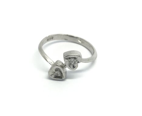 A platinum ring set with two diamonds in a double heart shaped design ring size K-L