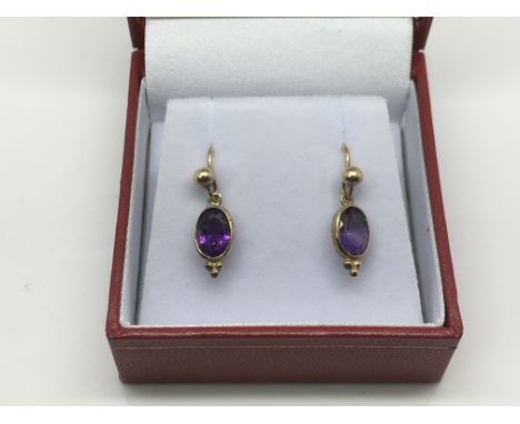 A pair of 9ct gold drop earrings set with amethyst, approx 1g.