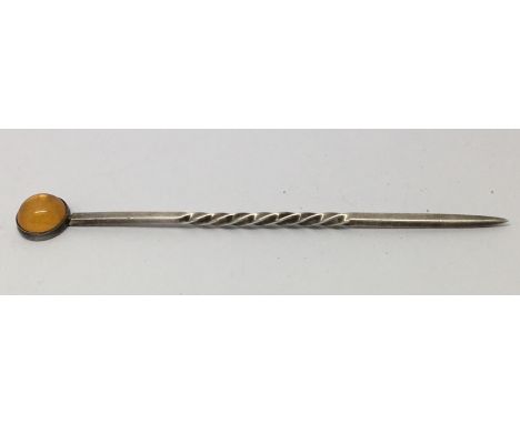 A Liberty &amp; Co. hallmarked silver stick pin set with amber.