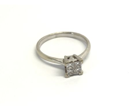 An 18carat White Gold ring set with four princesses cut diamonds ring size N.