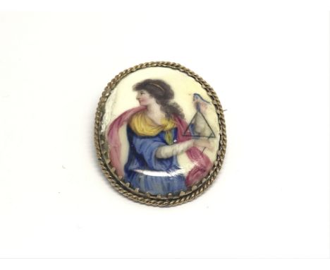 An antique gold mounted enamel on copper miniature portrait brooch of a maiden playing a triangle