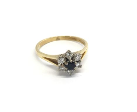 An 18carat gold ring set with a central blue sapphire and diamonds ring size O.