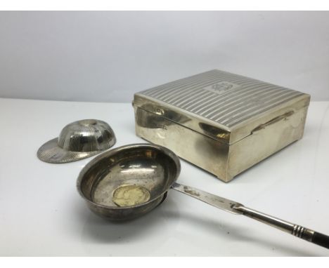 A silver cigarette box, toddy ladle inset with a Georgian coin plus a miniature silver jockey cap (3).