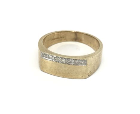 A 9carat gold ring set with a row of diamonds ring size T