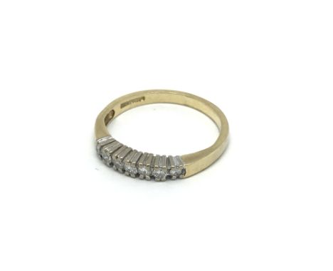 An 18carat yellow gold ring set with a row of seven brilliant cut diamonds ring size k-L.