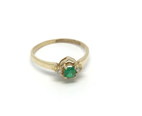 An 18carat Gold Emerald and diamond ring size K.