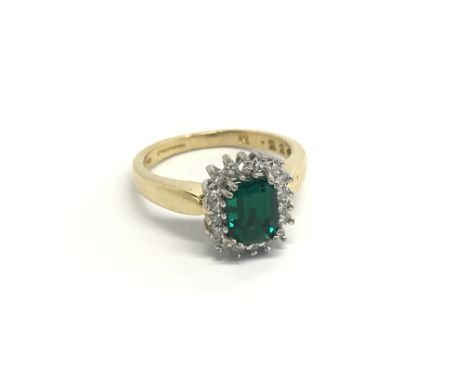 An 18carat gold ring set with a good size green tourmaline flanked by diamonds. ring size J.