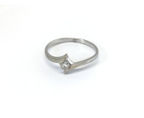 An 18carat gold ring set with a brilliant cut solitaire diamond approximately 0.14 of a carat. ring size M-N