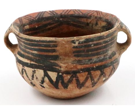 A Neolithic period painted terracotta twin handled pot, decorated with geometric designs, repaired crack from rim to base, H: