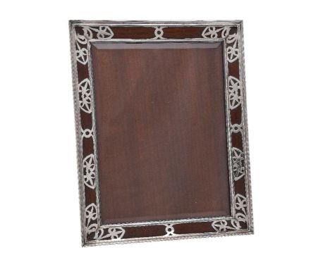 An Edwardian silver photograph frame by William Comyns &amp; Sons, London 1909, rectangular, the frame pierced with stylised 