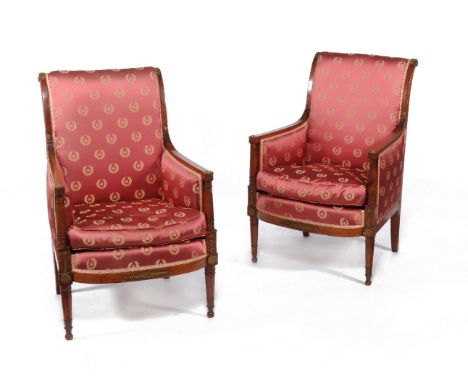 A suite of Continental fruitwood seat furniture, in Empire style, 19th century, comprising two bergeres and a sofa, each padd